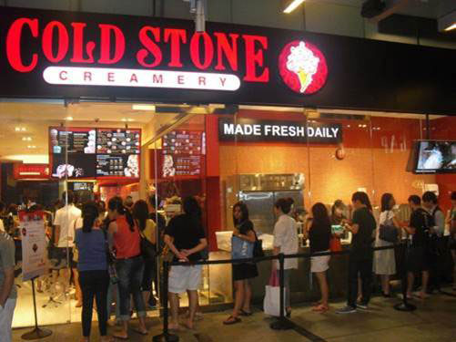 Customers waiting in line at a Cold Stone Creamery in Singapore.