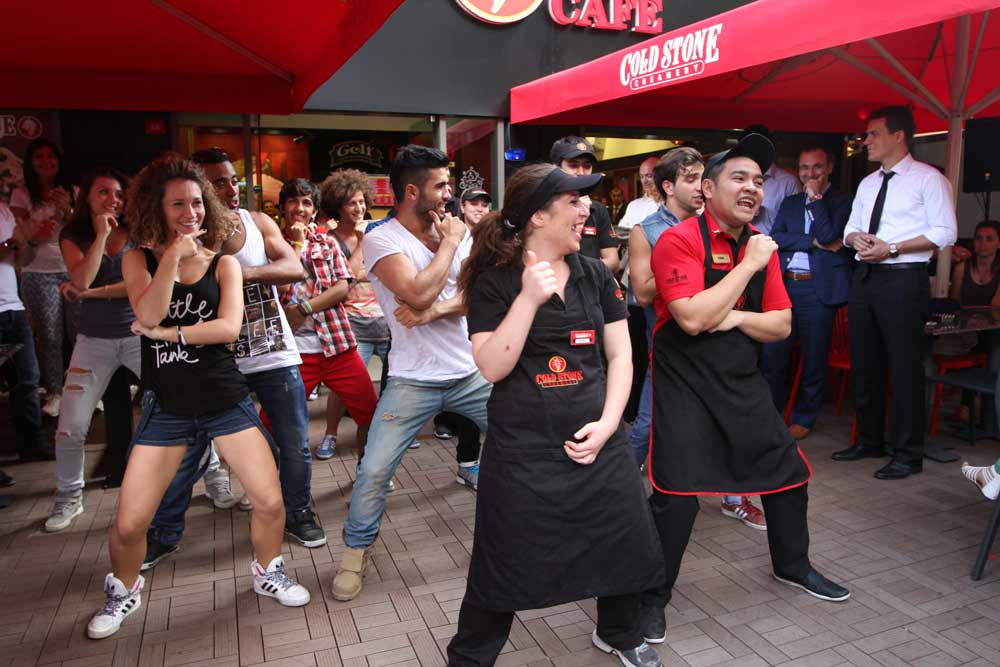 Cold Stone Creamery employees and customers dancing during the grand opening in Turkey.